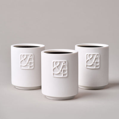 AUGUST&PIERS 90g white ceramic candles with embossed 'A&P' logos on the front, displayed on a neutral background.