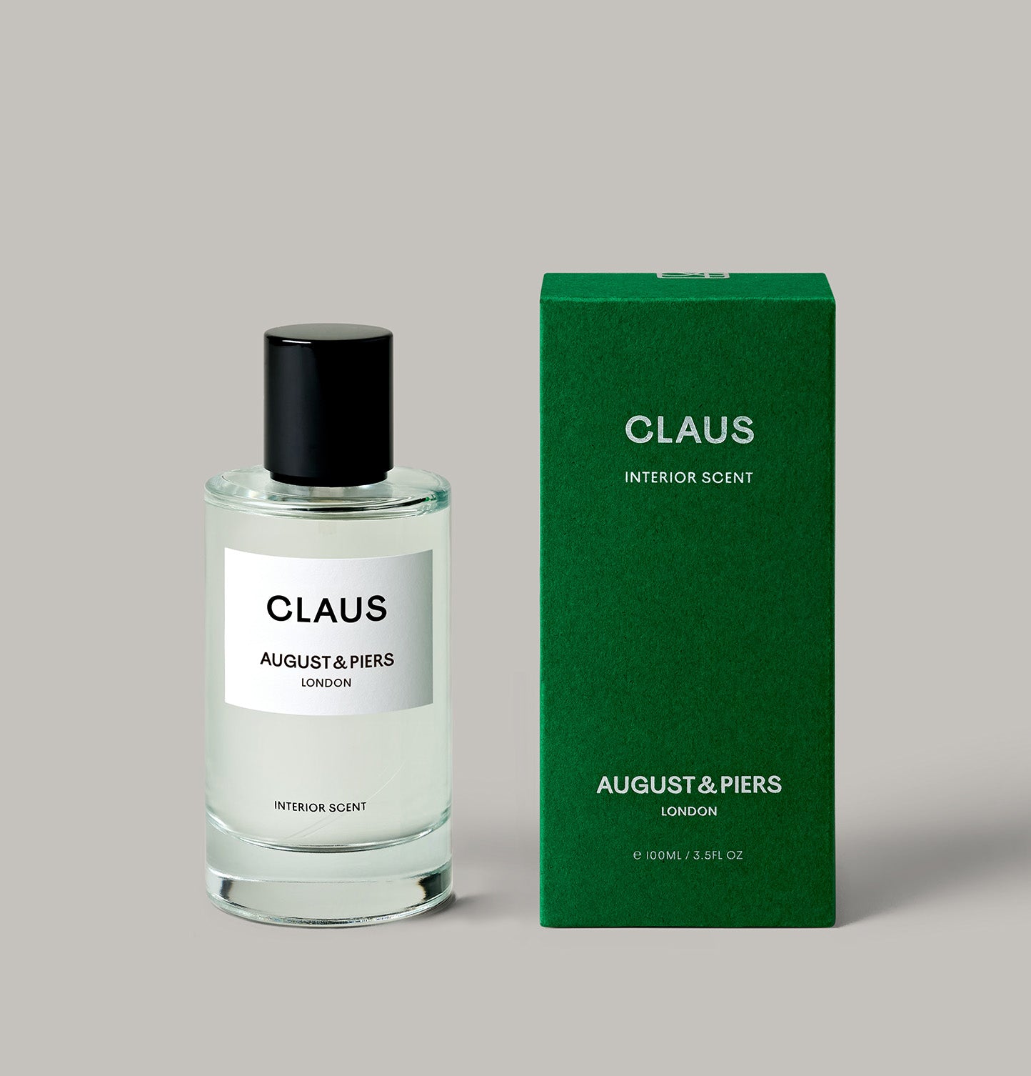 AUGUST&PIERS CLAUS room spray in glass bottle and green box with – festive home fragrance with pine and cinnamon notes.