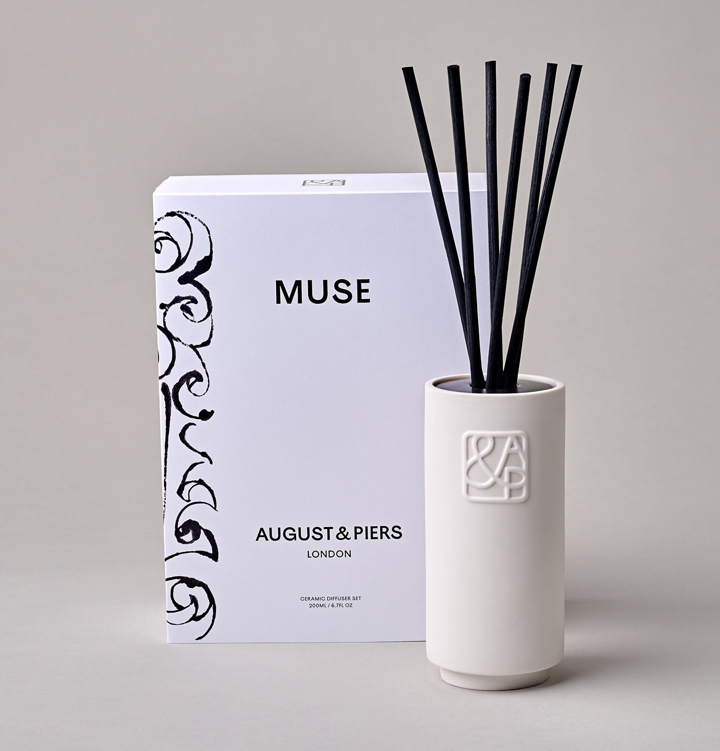 AUGUST&PIERS 200ml Muse Diffuser with embossed 'A&P' logos on the front, displayed alongside their packaging box featuring an illustration by Petra Börner, set against a neutral background.