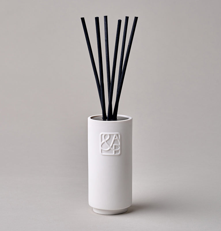 AUGUST&PIERS 200ml white ceramic diffuser with embossed 'A&P' logos on the front, displayed on a neutral background.