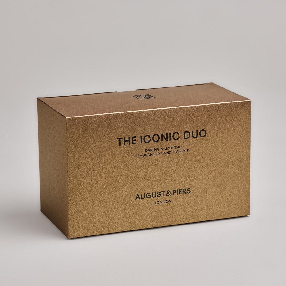 The Iconic Duo Gift Set by AUGUST&PIERS London. This set features the Darling and Libertine scented candles in limited-edition dark gold packaging.