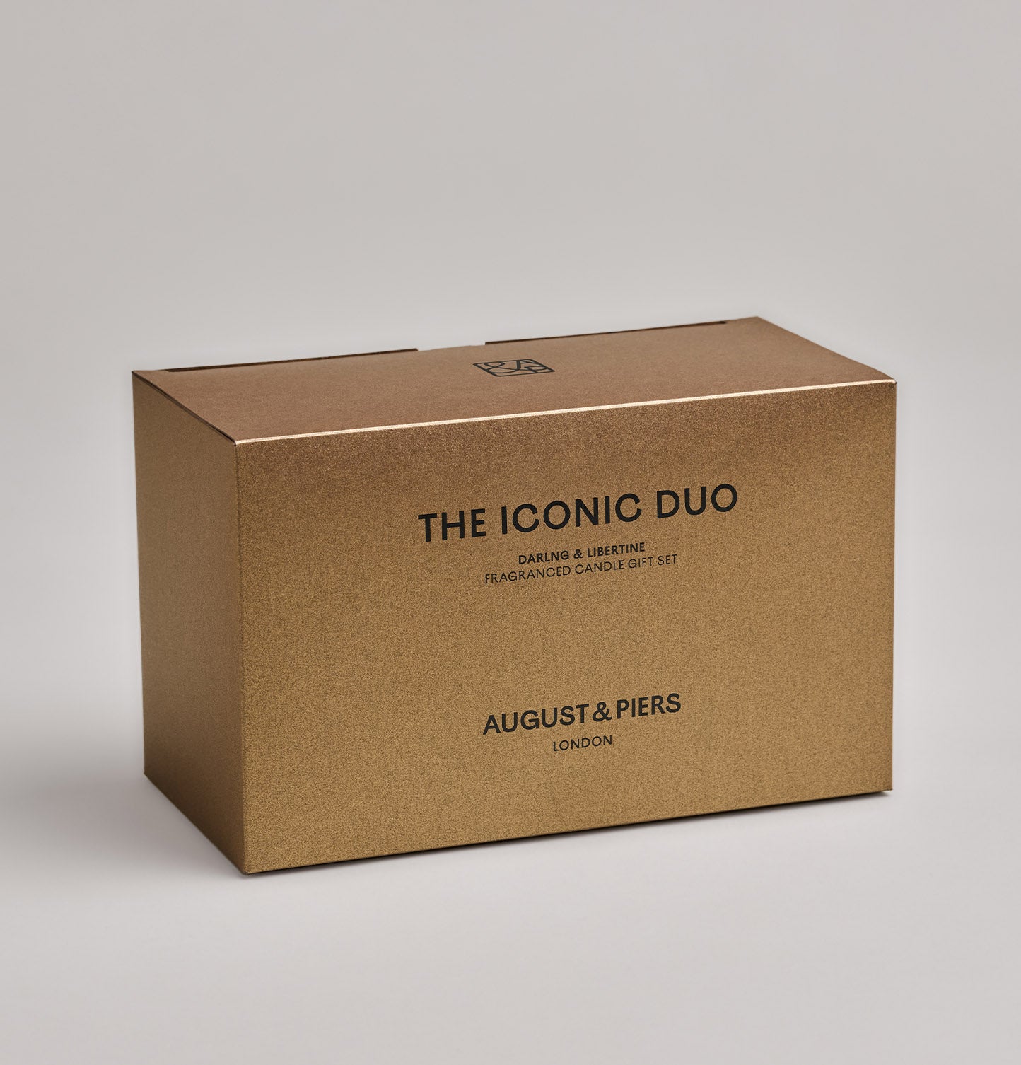 The Iconic Duo Gift Set by AUGUST&PIERS London. This set features the Darling and Libertine scented candles in limited-edition dark gold packaging.