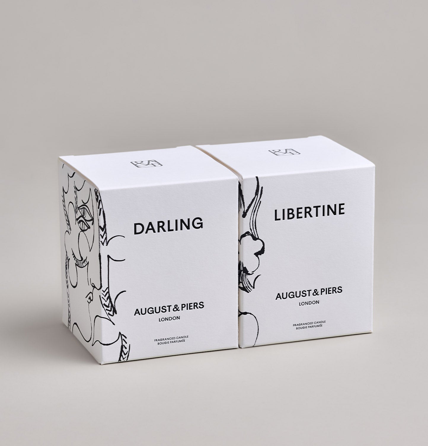 The Iconic Duo Gift Set by AUGUST&PIERS London. This set features the Darling and Libertine scented candles in limited-edition dark gold packaging.